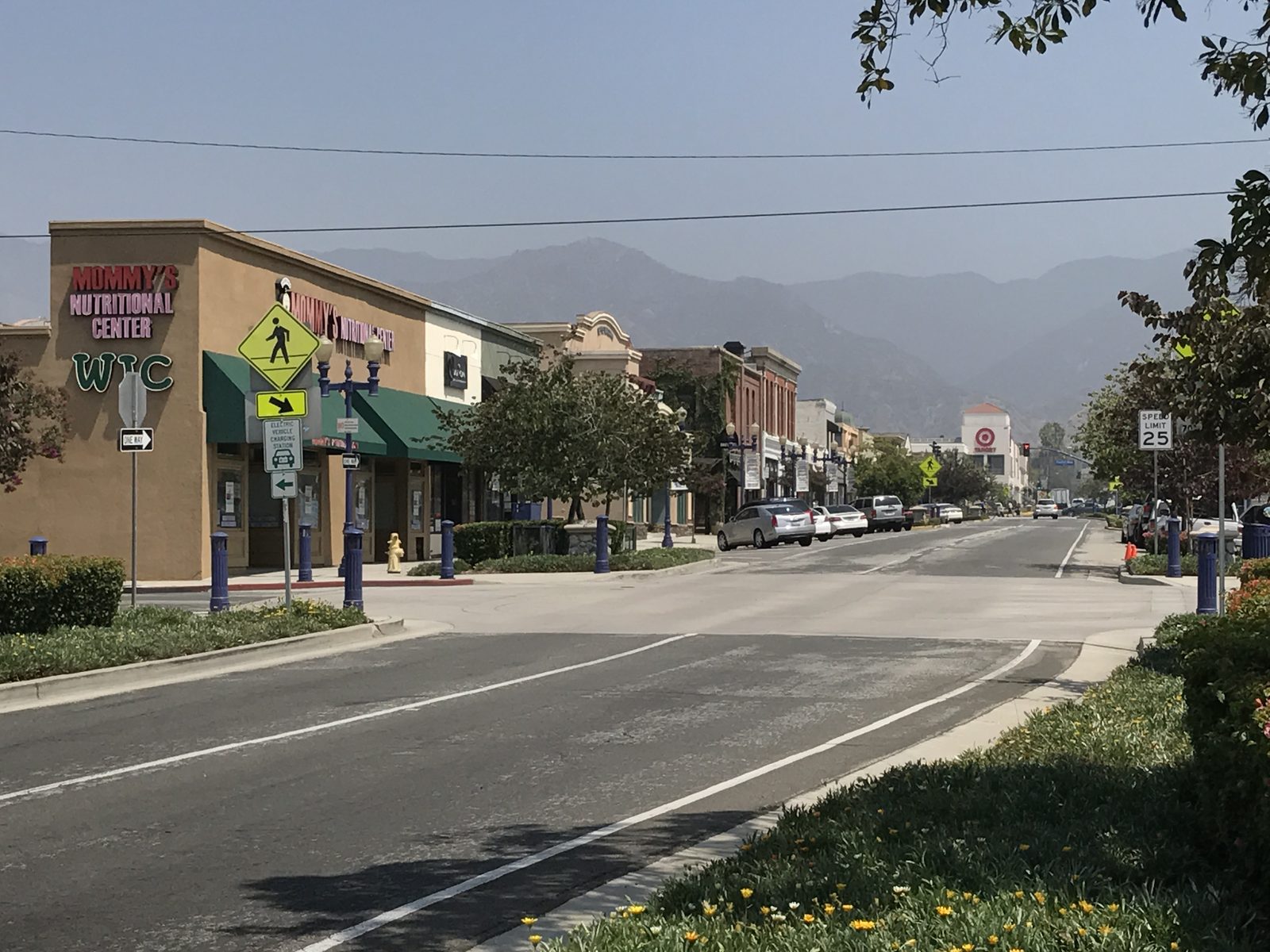 Commercial street in downtown Azusa, California, with the San Gabriel Mountains behind