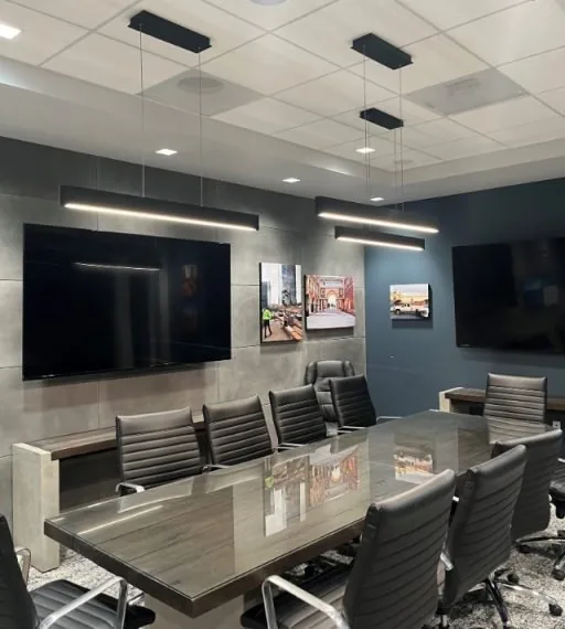 DV Contractors conference room with linear LED pendant lights, recessed lighting and wall-mounted displays
