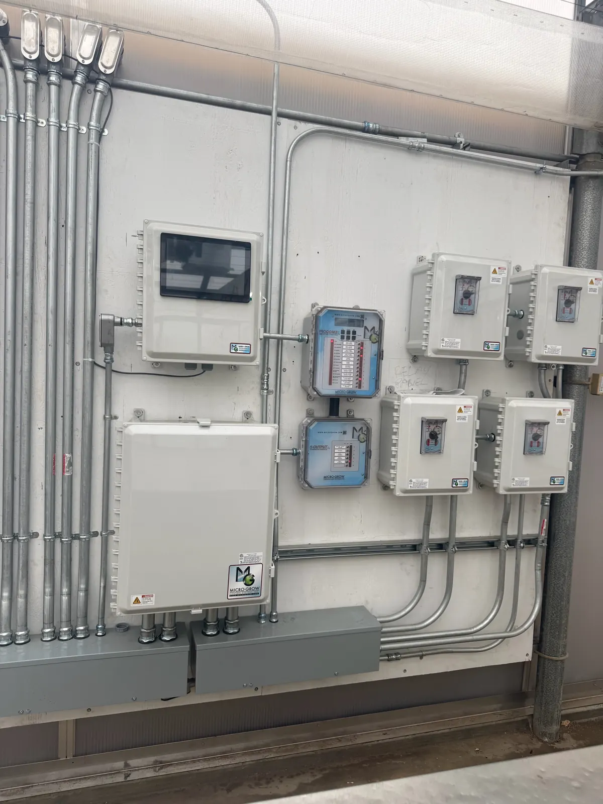 Close-up of greenhouse control panels, a touchscreen controller and conduit connections at the LA County Arboretum in Arcadia
