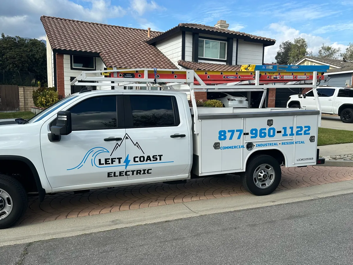 Left Coast Electric service truck parked in front of a two-story home with a tile roof