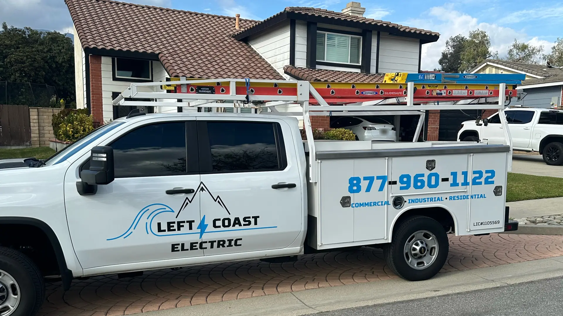 Left Coast Electric service truck parked in front of a two-story home with a tile roof