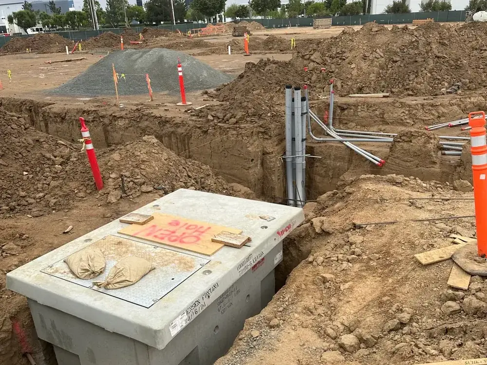 Precast underground electrical vault and conduit stub-ups during site work for a ground-up warehouse in Moreno Valley, CA