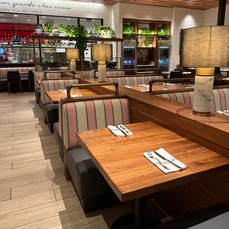 Booth seating with table lamps at North Italia Brea