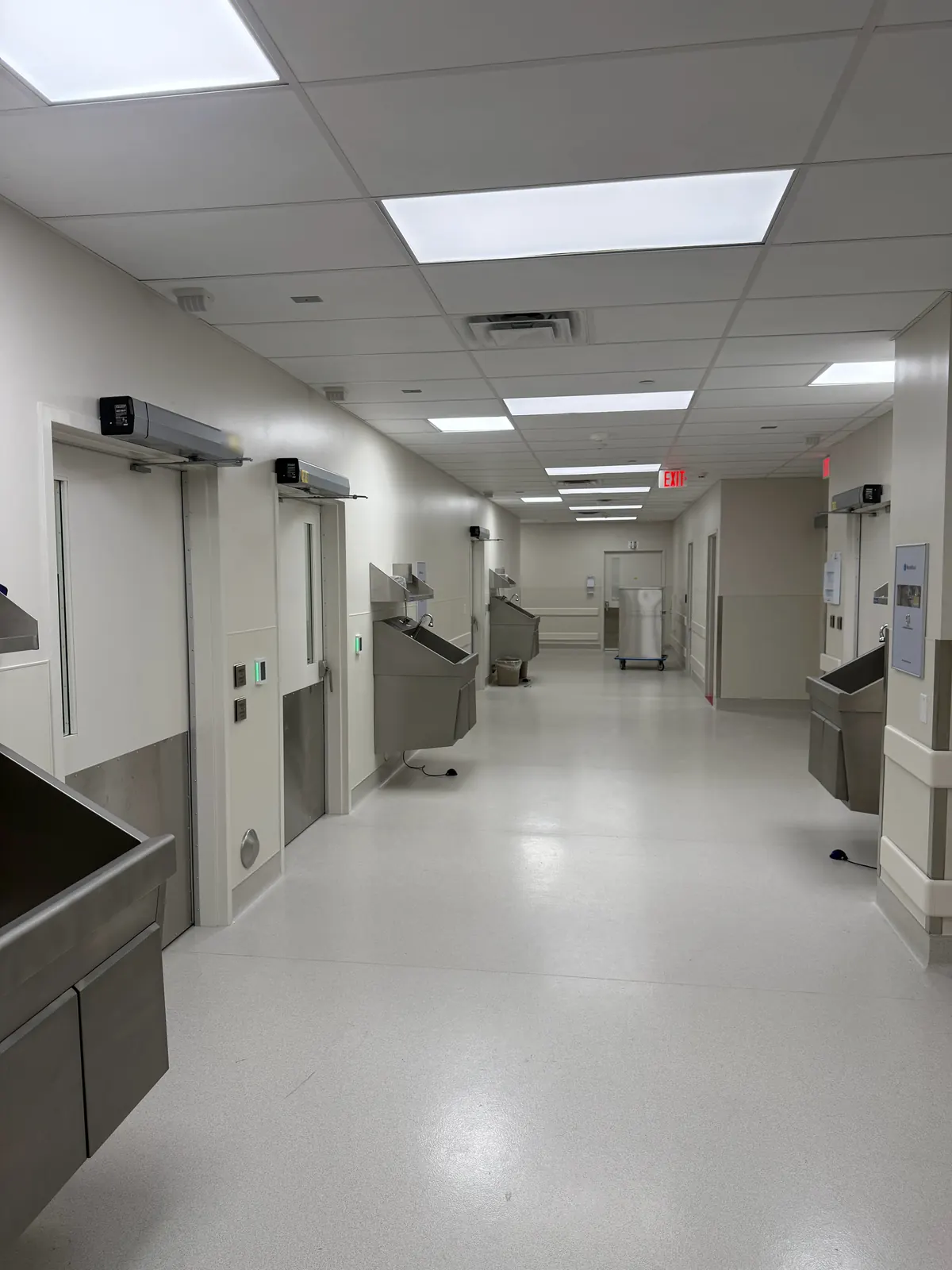 Corridor at Ortho AZ in Glendale, AZ, with automatic door operators above the doors, card readers, push plates and scrub sinks