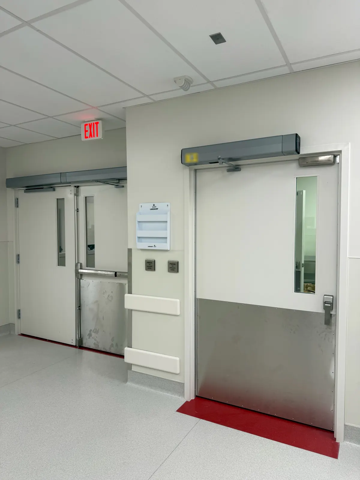Double doors and a single door, each with an automatic door operator, plus wall-mounted push plates, at Ortho AZ in Glendale, AZ