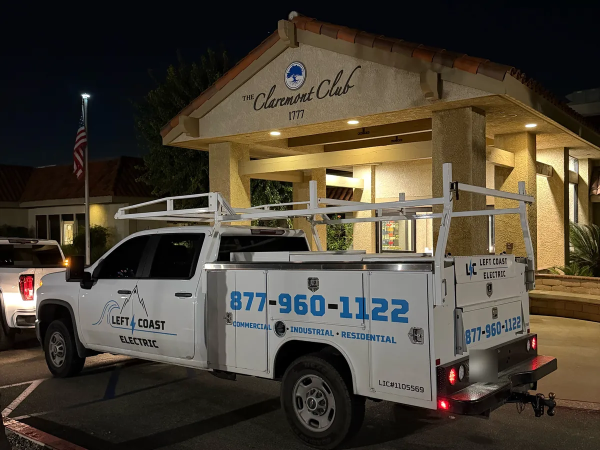 Left Coast Electric service truck parked at night in front of The Claremont Club entrance sign (1777) in Claremont, CA
