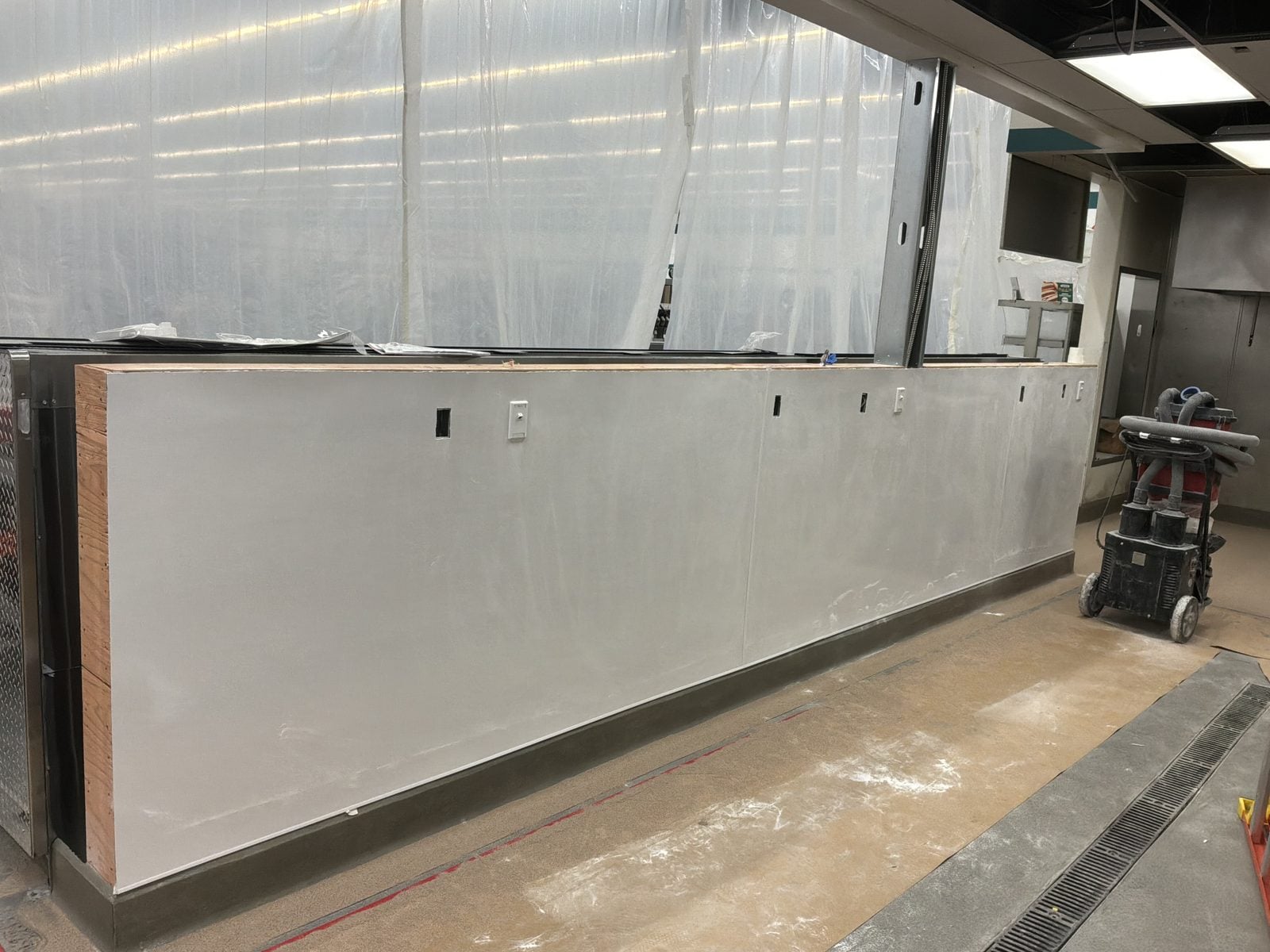 Finished wall with receptacles along the refrigerated case line at WinCo Foods in Hemet, CA